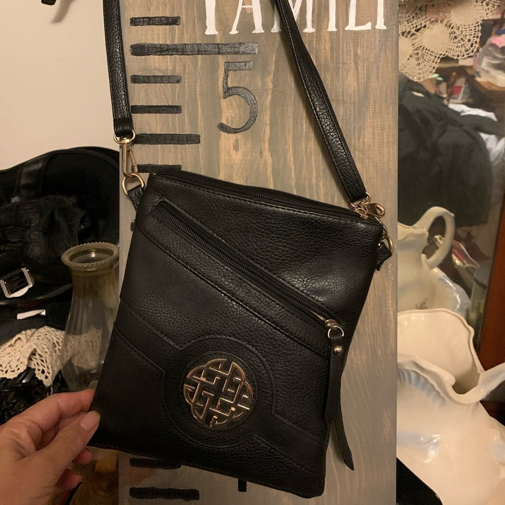 Black crossbody purse with adjustable shoulder strap. No scratches or tears. SFH